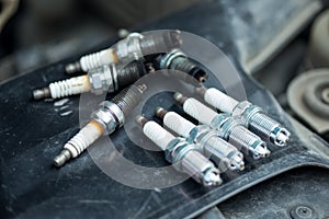 Worn and new spark plugs