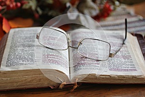 Worn Open Bible with Glasses