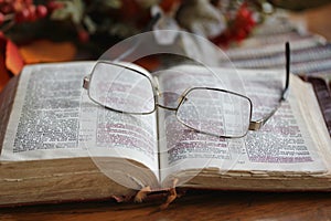 Worn Open Bible with Glasses photo