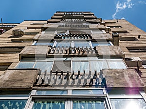 Worn out apartment building from the communist era against blue sky in Bucharest Romania