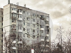 Worn out apartment building from the communist era against blue sky in Bucharest Romania.