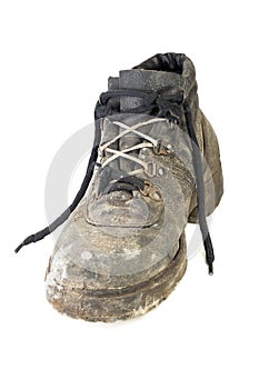 Worn-out old work boot, isolated on white background with shadow