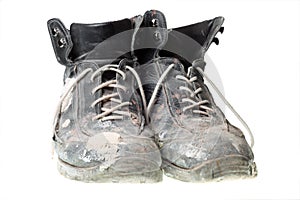 Worn-out old work boots, isolated on white.