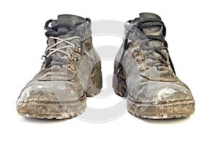 Worn-out old work boots isolated on white background