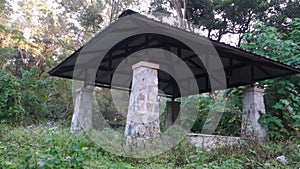 Worn out outdoor park with remains of stone walls and walk-throughs. India