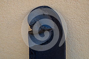 Worn-out shoe insole on wall, showing the hopeless situation of refugees trying to illegally enter the country, bypassing border