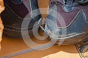 Worn-out shoe showing the growth of inflation and the aggravation of the economic situation, in which residents have to refuse to photo