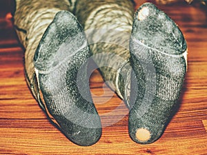 Worn out socks with holes and toes sticking out photo