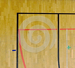 Worn out wooden floor of sporting hall with black red marking lines.