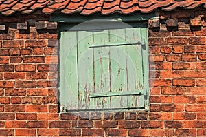 Worn Small Wooden Door set in Old Bricks