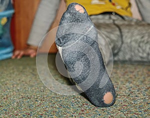 Worn socks with a hole and heel sticking out