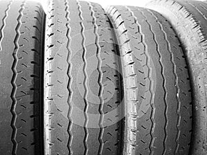 worn tyres stacked side by side sidelit