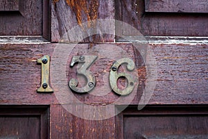 Worn & weathered house number 136