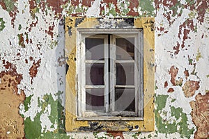 Worn wheathered peeled painted wall with window