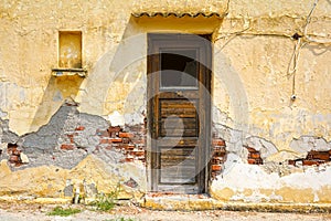 Worn wooden door in a weathered wall
