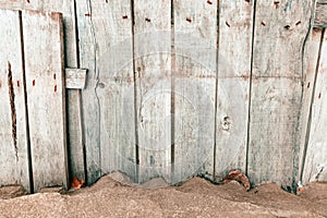 Worn wooden fence on sandy beach as copy space