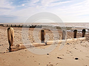 Worn wooden groins on a beach