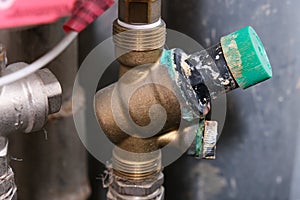 Worn woter supply equipment, leaking corroded water flow regulator, reducer, plumbing repair concept