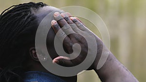 Worried african man with a headache massaging the temples