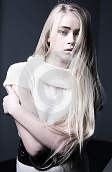 Worried, anxious, depressed teenager girl with blond long hair