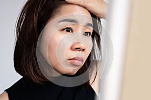Asian woman have problem with oily skin on t zone of her face photo