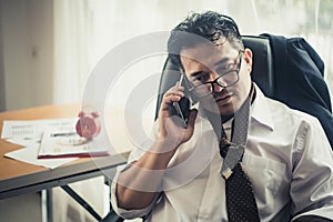 Worried business man at workplace in office after tired from hard work.