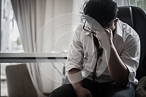 Worried business man at workplace in office after tired from hard work.