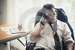 Worried business man at workplace in office after tired from hard work.