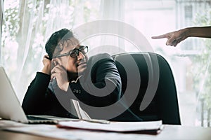 Worried business man at workplace in office after tired from hard work.