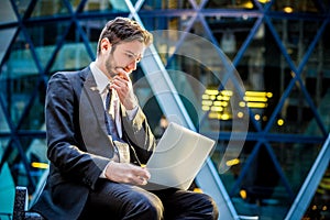 Worried businessman on laptop computer