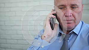 Worried businessman making a phone call disappointed and upset