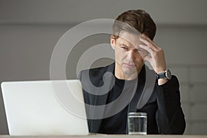 Worried businessman trying to understand reasons of company cris