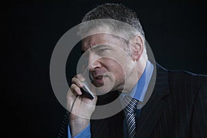 Worried Businessman Using Landline Phone