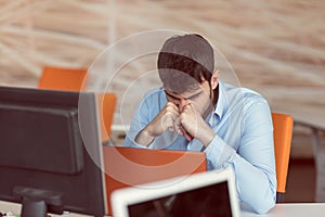 Worried businessman working at his desk in his office