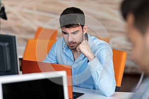 Worried businessman working at his desk in his office