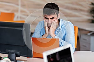 Worried businessman working at his desk in his office