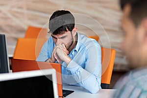 Worried businessman working at his desk in his office