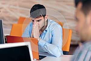 Worried businessman working at his desk in his office