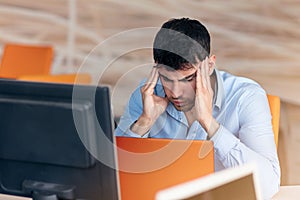 Worried businessman working at his desk in his office