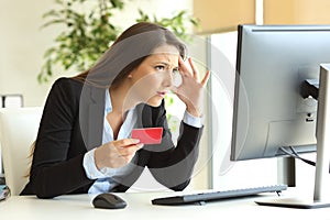 Worried businesswoman buying with credit card