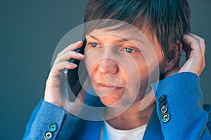 Worried businesswoman during unpleasant telephone conversation