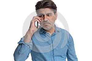 Worried casual man talking on his phone