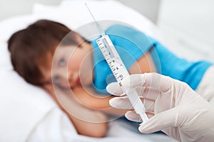 Worried child about to receive an injection photo