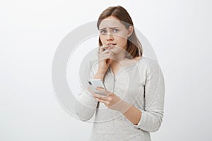 Worried and concerned girl feeling anxious parent find out daring photos leaked in social networks looking nervously and