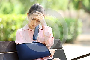 Worried convalescent woman in a park photo