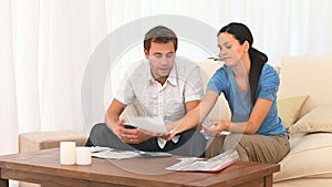 Worried couple calculating their domestic bills