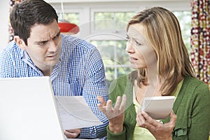 Worried Couple Discussing Domestic Finances At Home