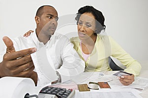 Worried Couple With Expense Receipt And Credit Cards photo