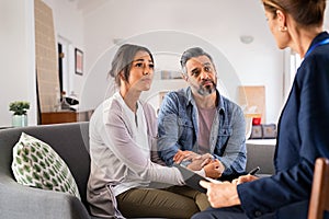 Worried couple meeting social counselor