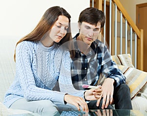 Worried couple with pregnancy test